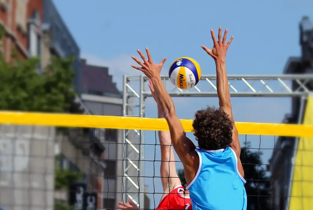 beach volleyball blocking over net view of shoulder